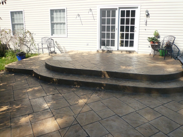 Curved stamped concrete patio with steps