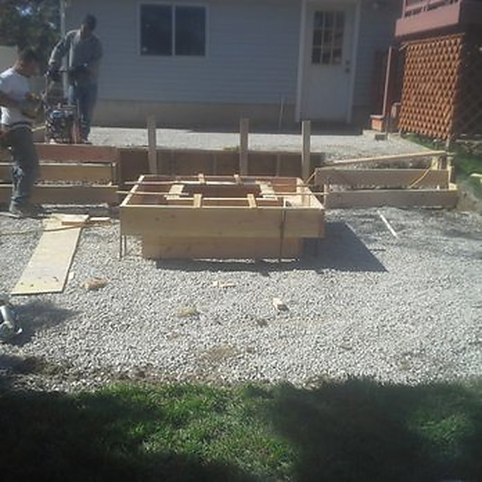 Concrete forms being built for a patio extension